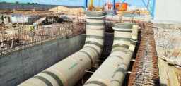 Large industrial construction project with cranes and building infrastructure